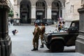 Two soldiers, a military vehicle and a kid taking a photograph on the square in front of The Naples Royalty Free Stock Photo
