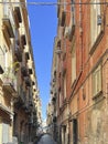 Narrow street in the old part of Naples filled with a large number of parked motorbikes, scooters and mopeds Royalty Free Stock Photo