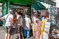 Naples, Italy. September 11th, 2011. Group of people, mostly older people, in front of a newsstand in Piazza Trieste e Trento