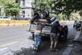 Two men pushing a damaged van in Naples, Italy