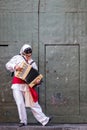 Street entertainer in mask, playing accordion. Photographed in Naples, Italy.