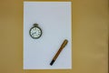 On a white sheet, an old gold fountain pen and an old pocket watch. The pen and the clock date back to the early 1900s, in fact yo Royalty Free Stock Photo