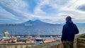 Naples - Man at the Castel dell Ovo with view on the summit of mount Vesuvius in Naples, Italy, Europe Royalty Free Stock Photo