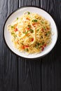 Naples traditional Aglio e Olio spaghetti close-up in a plate. Vertical top view Royalty Free Stock Photo