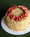 Napoleon cake with fresh strawberries on top served on a white plate with blurred background. Dessert time Royalty Free Stock Photo