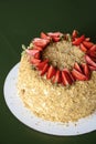 Napoleon cake with fresh strawberries on top served on a white plate with blurred background. Dessert time Royalty Free Stock Photo