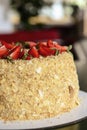 Napoleon cake with fresh strawberries on top served on a white plate with blurred background. Dessert time Royalty Free Stock Photo