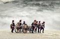 Napoleonic soldiers marching in open plain land with dramatic clouds., pulling a cannon.