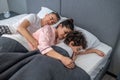 Cute family sleeping together in one bed Royalty Free Stock Photo