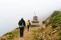 Backpackers entering Nar village on foggy trekking path in Annapurna Conservation Area, Nepal Royalty Free Stock Photo