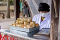 Japanese female trader and her Japanese snack `Sembe` for feed to deer in small booth,