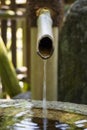 Close up of a traditional bamboo water pipe near the temple to clean your hands and mouth