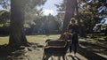 Young tourist feeds deer at the park in Nara, Japan