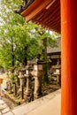 NARA, Japan. Row of old traditional japanese stone lanterns toro coverd with green vivid moss in Nara Park, Japan. Royalty Free Stock Photo