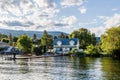 NARAMATA, CANADA - JULY 5, 2020: Lake house with pier and green trees on the shore