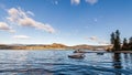 NARAMATA, CANADA - JULY 4, 2020: motor boats on the morning summer lake blue sky and white clouds