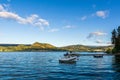 NARAMATA, CANADA - JULY 4, 2020: motor boats on the morning summer lake blue sky and white clouds