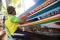 Man painting Malayu style art on boat.is call