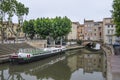 Narbonne, France and the Canal de la Robine. Houses on bridge