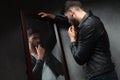 Narcissist young man admiring himself in the mirror Royalty Free Stock Photo