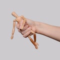 A narcissistic parent. A wooden mannequin in the hand of an adult who tortures and abuses her. Metaphor with domestic violence