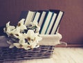 Narcissus and books in a wattled basket.