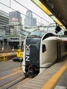 Narita Express train at Shinjuku station with Cocoon tower back Royalty Free Stock Photo