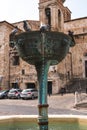 Narni, Italy - July 27, 2019: Central fountain, pigeons and water, medieval city: a typical old street. Vertical photo Terni,