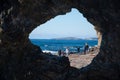 People waliking near unusual rock formation near Wagonga Head in Narooma called Australia rock.