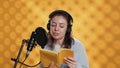 Narrator reading from book into mic, exhaling after finally finishing job