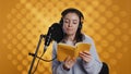 Narrator reading from book into mic, exhaling after finally finishing job