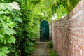 Narrow access path to a wooden garden gate Royalty Free Stock Photo