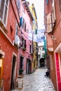 Narrow Alley With Street Life In The Old Town Of The City Of Rovinj In Croatia Royalty Free Stock Photo