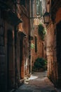 A narrow alley, cool and dim, yet touched by soft sunlight and shadows that tell tales of the day\'s end Royalty Free Stock Photo