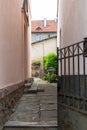 narrow alley between houses facing the courtyard