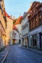 Narrow alley of medieval houses in the city of Tallinn at sunrise.