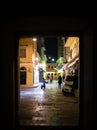 Narrow alley at night with the people Corfu island, Greece. Old town street at night. Night life Royalty Free Stock Photo