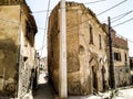 Narrow alley in old Algerian city of Ksar El Boukhari between two old stone houses. North African streets and alleys