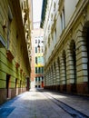 Narrow alley in old Budapest with arched windows and stone pavement