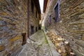 Narrow alley between old stone houses, a bicycle and firewood logs for the winter. La Hiruela Madrid Royalty Free Stock Photo