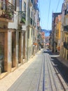 Narrow alley with rails of the bica elevator ascesor da bica in lisbon