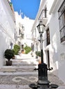 Narrow alley with stairs between white houses in a small Spanish mountain village in Andalusia, narrow street, sight, andalusia, Royalty Free Stock Photo