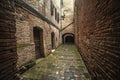 Narrow alley surrounded by stone walls in Buonconvento