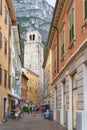 Narrow alley with tourists in the popular historic old town of Riva del Garda in Italy Royalty Free Stock Photo