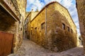 Narrow alleys with medieval stone houses in the old village of Madremanya, Girona. Royalty Free Stock Photo