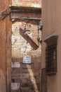 narrow alleyway, surrounded by brick walls in Italy