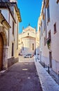 Narrow ancient street flowers sidewalk stone steps colorful facade Italy center Verona Royalty Free Stock Photo