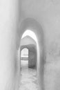 Narrow archway of aged building with smooth shabby walls and tiled floor