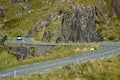 Narrow asphalt road winding among the green hills of Ireland. Molls Gap. Ring of Kerry.