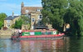 Narrow boat cruising along the river Ouse at St Neots